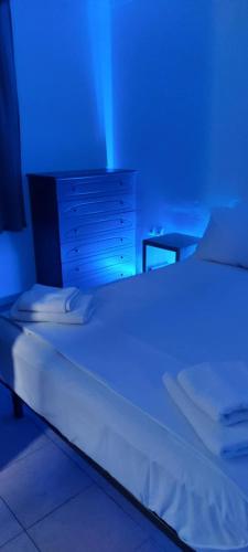 a bedroom with a bed with a blue light at Ionian Casa Azul in Karavomylos