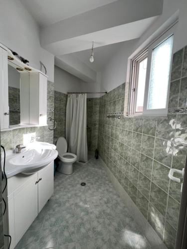 a bathroom with a sink and a toilet and a shower at City Center Hotel in Sarandë