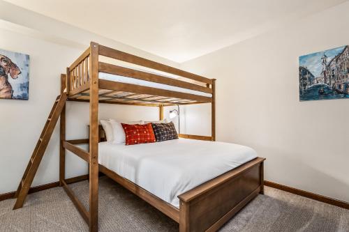 a bedroom with a bunk bed with a bunk ladder at Seasons Alpine Retreat in Avon