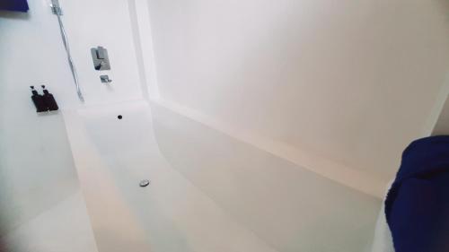 a room with a white wall with a phone at Anchor House in Ahangama