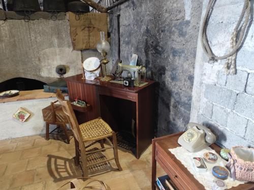 a room with a desk and a chair in a room at Villa Etna Masi' in Milo