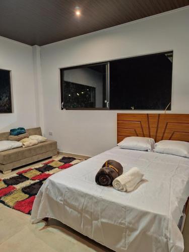a bedroom with two beds and a large window at Estancia Mirador Reyes- Casa de la Montaña in Zamora