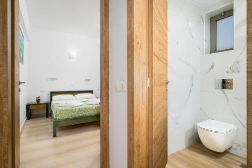 a bathroom with a bed and a toilet in a room at Nikolas Villas Appartments in Hersonissos