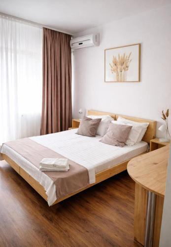 a bedroom with a large bed with white sheets at Adori Boutique in Eforie Nord