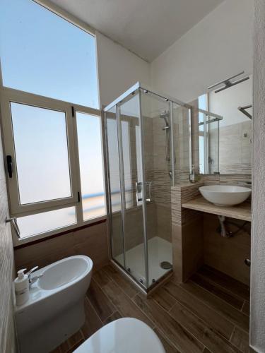 a bathroom with a shower and a toilet and a sink at B&B Casa Lamanna in Torretta