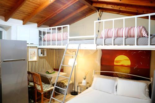 a bedroom with two bunk beds and a desk at The Nest in Astris