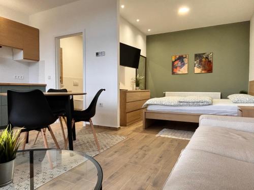 a room with a bed and a desk and a table at NOAR Enjoy Your Stay in Orešje