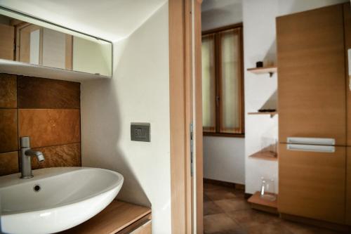 a bathroom with a sink and a mirror at Roncati Family Apartment in Bellagio