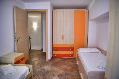 a small room with two beds and a closet at Roncati Family Apartment in Bellagio