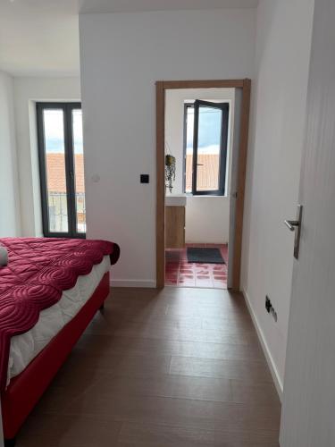 a bedroom with a bed and a door to a hallway at Casa Albertina in Mogofores