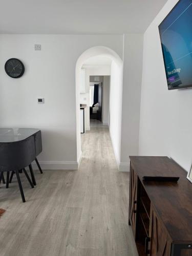 a living room with a piano and a table at Ground Floor Flat with Courtyard garden in Weston-super-Mare
