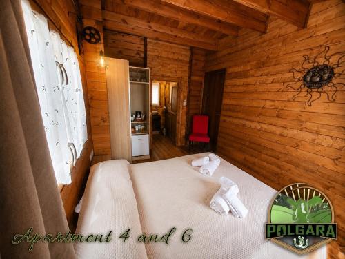 a bedroom with a bed in a wooden cabin at Agriturismo Polgara in Lari