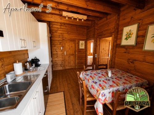a kitchen and dining room with a table in a cabin at Agriturismo Polgara in Lari