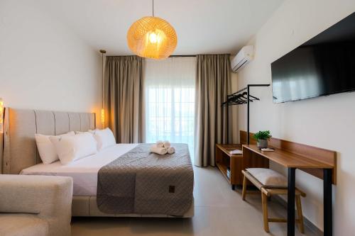 a hotel room with a bed and a desk at Blue Bay Hotel in Skala Potamias