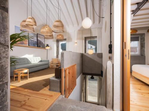 a living room with a fireplace in a house at GuestReady - ALMA - Island House in Faial da Terra