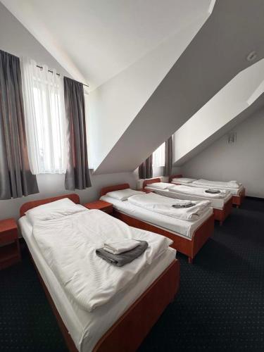 a row of beds in a hotel room at Hotel Jan in Zgorzelec