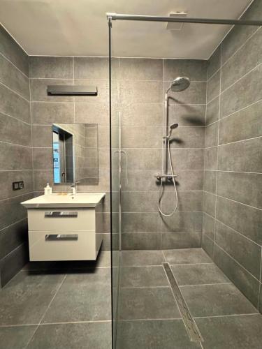 a bathroom with a shower and a sink at Hotel Jan in Zgorzelec