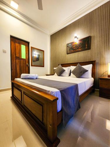 a bedroom with a large bed in a room at Breezy River in Kalutara