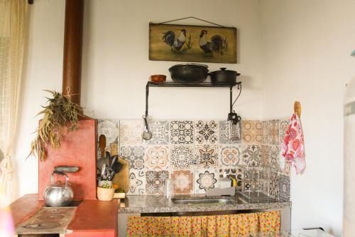 a kitchen with a tiled counter top with a sink at Casa Aroni - 1300m altitude in Extrema