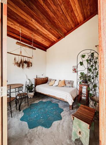 a bedroom with a bed and a table in a room at Casa Aroni - 1300m altitude in Extrema