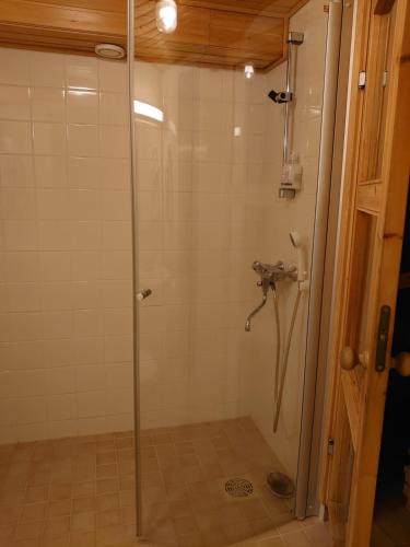 a shower with a glass door in a bathroom at Holidayhome RintintinTahko in Tahkovuori