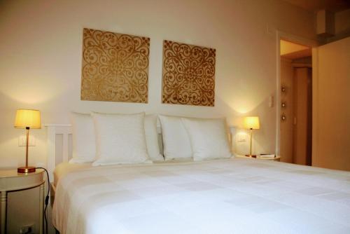 a bedroom with a large bed with white pillows at Casa Bruna in Levanto