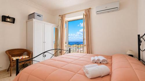 a bedroom with a large orange bed with towels on it at Apartment Casa Beatrice in Pizzo