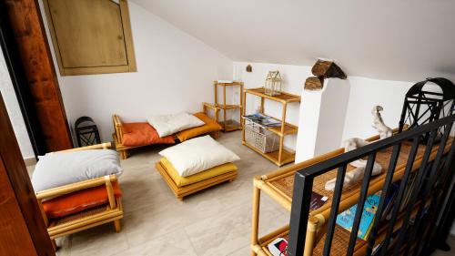 a living room with several chairs and a staircase at Apartment Casa Beatrice in Pizzo