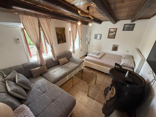 a living room with a couch and a table at Lake Escape Dodoši in Dodoši