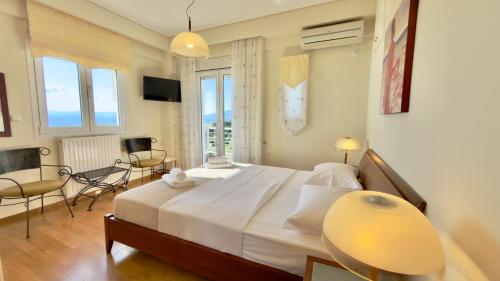 a bedroom with a large bed and a table and chairs at Lumaverde Estate in Kalamata