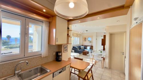 a kitchen and living room with a sink and a table at Lumaverde Estate in Kalamata
