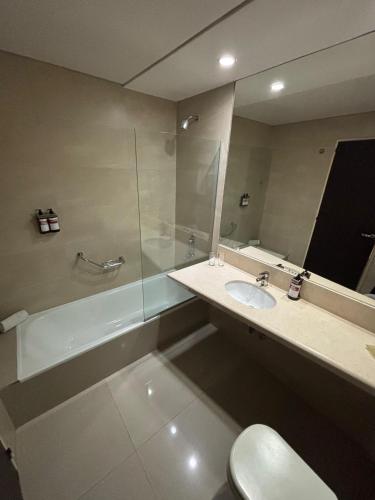 a bathroom with a sink and a shower and a toilet at Amérian Rosario in Rosario