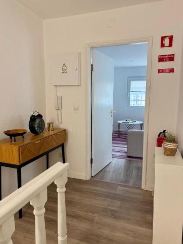 a hallway with a door leading to a living room at O Refúgio dos Ferreiros in Guarda