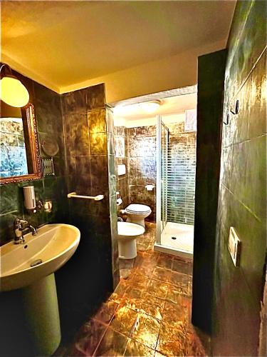 a bathroom with a sink and a toilet at Boutique Hotel L'Imperatrice -Vicinissimi a Valdichiana Designer Village- in Foiano della Chiana