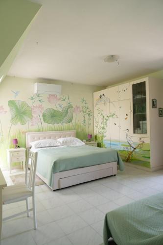 a bedroom with a bed with a painting on the wall at La Casa di Mimma in Caposele