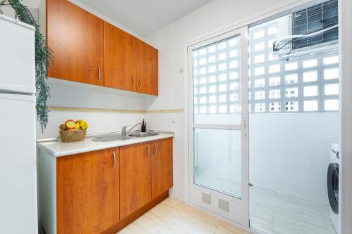 a kitchen with a sink and a window at Apto Oasis Playa & Golf Almerimar in Almerimar