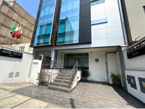 a building with a staircase in front of it at Hotel Inclan in Lima
