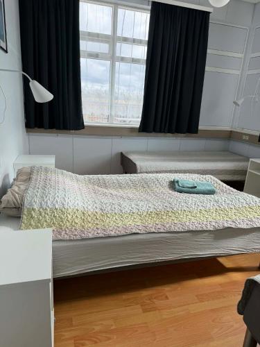 a bedroom with two beds and a window at Guesthouse Langafit in Laugarbakki