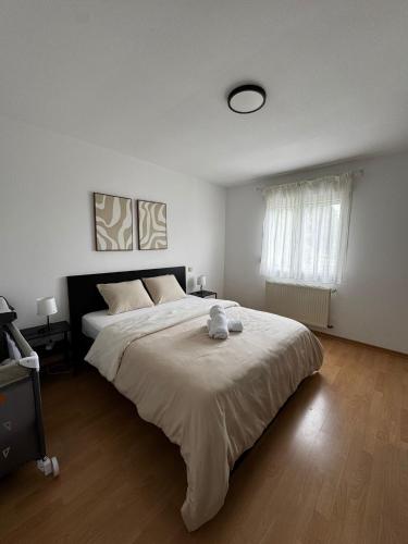 a bedroom with a large bed and a window at Zen House - Shopping at 3 min in Marnach