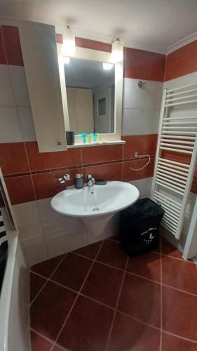 a bathroom with a white sink and a mirror at P&M House in Agrinio