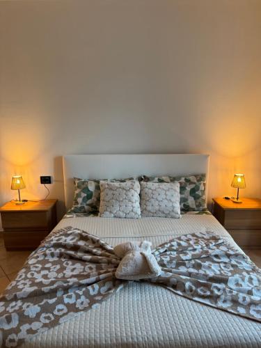 a bedroom with a large bed with two lamps at Casa Speranza in Narzole