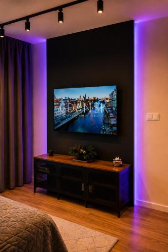 a room with a flat screen tv on a wall at Apart Studio Śródmieście in Gdańsk