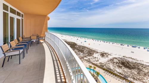 a balcony with chairs and the beach at Phoenix Gulf Towers 805 condo in Gulf Shores