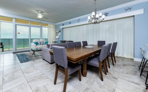 a dining room with a table and chairs at Phoenix Gulf Towers 805 condo in Gulf Shores