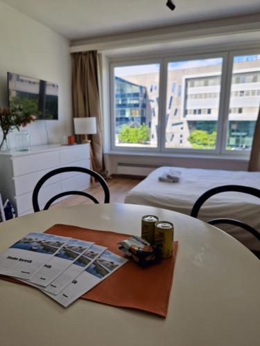 a room with a table with a magazine on it at Studio Kortrijk in Kortrijk