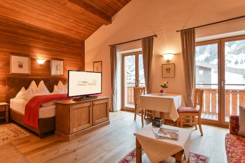 ein Schlafzimmer mit einem Bett und einem TV in einem Zimmer in der Unterkunft Chalet Anna Maria in Lech am Arlberg