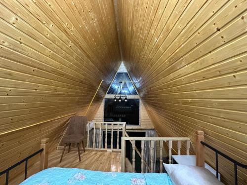 a room with a large wooden ceiling with a bed in it at cottages house in Namlisevi