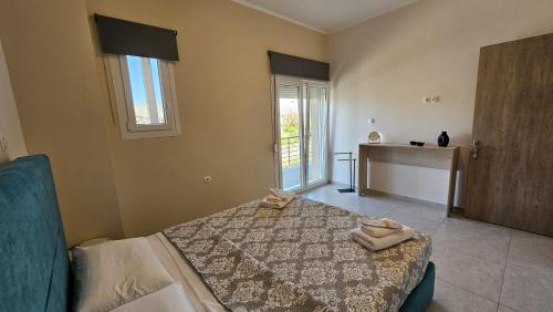 a bedroom with a bed with two towels on it at Estia Chios Apartments B3 in Karfas