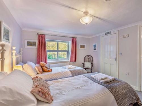 a bedroom with two beds with a teddy bear sitting on top at 4 Bed in Bishop Auckland oc-93527 in Wear Head