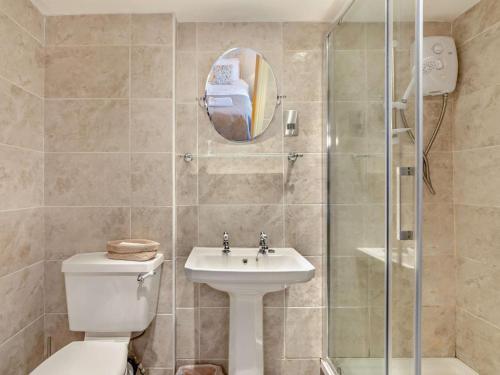 a bathroom with a toilet and a sink and a shower at 4 Bed in Bishop Auckland oc-93527 in Wear Head